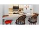 Open kitchen layout with breakfast bar seating, white countertops, and essential appliances in view at 1928 Las Palmas Ln # 228, Laughlin, NV 89029