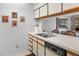 The kitchen features a sink and dishwasher next to a decorative dining area adorned with wall art at 1928 Las Palmas Ln # 228, Laughlin, NV 89029