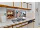 Kitchen sink and dishwasher with a view into the dining and living area, creating an open-concept feel at 1928 Las Palmas Ln # 228, Laughlin, NV 89029