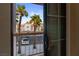 View from patio shows tropical trees, parking lot, and a building across the way at 1928 Las Palmas Ln # 228, Laughlin, NV 89029