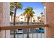 View from patio shows tropical trees, parking lot, and a building across the way at 1928 Las Palmas Ln # 228, Laughlin, NV 89029