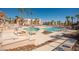 Inviting community pool area with lounge chairs and clear blue water, surrounded by palm trees and condos at 1928 Las Palmas Ln # 228, Laughlin, NV 89029