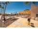 Inviting community pool and shaded seating area with outdoor grill, desert landscaping, and seating area at 1928 Las Palmas Ln # 228, Laughlin, NV 89029