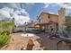 Spacious backyard featuring desert landscaping, patio, play area, and a covered porch for outdoor living at 1942 Old Mill Ln, Henderson, NV 89014