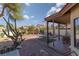 Expansive backyard oasis showcasing a covered patio, play area, and mature desert landscaping at 1942 Old Mill Ln, Henderson, NV 89014