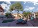 Relaxing backyard featuring a patio area and established desert landscaping at 1942 Old Mill Ln, Henderson, NV 89014