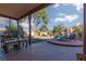 Lush backyard with a covered patio, mature trees, and outdoor seating at 1942 Old Mill Ln, Henderson, NV 89014