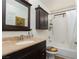 Cozy bathroom featuring a dark wood vanity and tub-shower combination at 1942 Old Mill Ln, Henderson, NV 89014