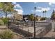 A decorative, wrought-iron antique carriage statue in a landscaped median within the community at 1942 Old Mill Ln, Henderson, NV 89014