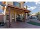 Charming covered patio area with ample seating and brickwork; a relaxing outdoor space at 1942 Old Mill Ln, Henderson, NV 89014