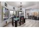 Inviting dining room with large windows, stylish lighting, and seating for six at 1942 Old Mill Ln, Henderson, NV 89014