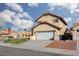 Charming two-story home with a two-car garage, desert landscaping, and a well-maintained front lawn at 1942 Old Mill Ln, Henderson, NV 89014