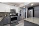 A well-lit kitchen with grey cabinets and stainless steel appliances at 1942 Old Mill Ln, Henderson, NV 89014