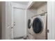 Laundry room with a modern washer and dryer at 1942 Old Mill Ln, Henderson, NV 89014