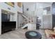 Open-concept living room with high ceilings, staircase, elegant decor, and plenty of natural light at 1942 Old Mill Ln, Henderson, NV 89014