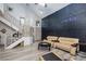Inviting living room with high ceilings, a staircase, and two comfortable armchairs at 1942 Old Mill Ln, Henderson, NV 89014