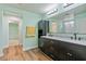 Bathroom boasts dual sinks, sleek dark cabinetry, and modern fixtures with views into a walk-in closet at 2037 Brush Stroke St, Henderson, NV 89044