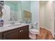 Bathroom featuring modern fixtures, including a sink, toilet, and shower, with wood-look flooring at 2037 Brush Stroke St, Henderson, NV 89044