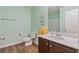 Bright bathroom featuring a vanity with a sink, wood flooring, and modern fixtures at 2037 Brush Stroke St, Henderson, NV 89044
