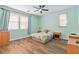 Cozy bedroom with hardwood floors, a ceiling fan, and plenty of natural light at 2037 Brush Stroke St, Henderson, NV 89044