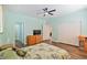 Light-filled bedroom with ceiling fan, wood floors, and en-suite bathroom at 2037 Brush Stroke St, Henderson, NV 89044