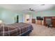 Bedroom with a TV, desk, ceiling fan, and large windows provides a versatile living space at 2037 Brush Stroke St, Henderson, NV 89044