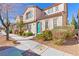 Charming two-story home with manicured landscaping and a unique turquoise front door at 2037 Brush Stroke St, Henderson, NV 89044