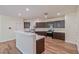 Open kitchen features dark cabinets, stainless steel appliances, and a breakfast bar at 2037 Brush Stroke St, Henderson, NV 89044
