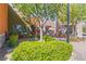 Charming outdoor seating area with vibrant orange chairs, striped umbrellas, and lush greenery at 2037 Brush Stroke St, Henderson, NV 89044