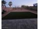 A backyard with artificial grass is enclosed by a block wall for privacy at 2077 Alki Beach Ave, Laughlin, NV 89029