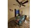 Bedroom featuring an overhead ceiling fan, a large window, and colorful decorations at 2077 Alki Beach Ave, Laughlin, NV 89029