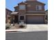 Beautiful two-story home with a two-car garage and tidy landscaping at 2077 Alki Beach Ave, Laughlin, NV 89029