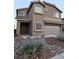 Inviting two-story home featuring a two-car garage and low-maintenance desert landscaping at 2077 Alki Beach Ave, Laughlin, NV 89029