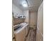 A well-lit laundry room includes modern washer and dryer units, storage shelving, and wood-look flooring at 2077 Alki Beach Ave, Laughlin, NV 89029