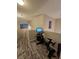 A bright loft space features wood-look flooring, a stationary exercise bike and natural light at 2077 Alki Beach Ave, Laughlin, NV 89029