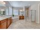 Well-lit bathroom boasting dual sinks, soaking tub, walk-in shower, and tile flooring at 2114 Twin Falls Dr, Henderson, NV 89044