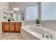 Bright bathroom highlighting a luxurious soaking tub, stylish fixtures, and ample natural light at 2114 Twin Falls Dr, Henderson, NV 89044