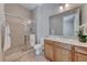 Bright bathroom featuring a glass enclosed shower, wood cabinets, and neutral countertops at 2114 Twin Falls Dr, Henderson, NV 89044