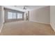 Expansive bedroom with a ceiling fan, plush carpet, and abundant natural light from multiple windows at 2114 Twin Falls Dr, Henderson, NV 89044