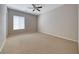 Comfortable bedroom featuring a ceiling fan, neutral carpet, and large window providing ample natural light at 2114 Twin Falls Dr, Henderson, NV 89044