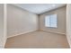Spacious bedroom featuring neutral carpet, light-filled window, and modern recessed lighting at 2114 Twin Falls Dr, Henderson, NV 89044