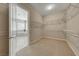 Spacious walk-in closet with built-in shelving, carpet, and doorway to the bathroom at 2114 Twin Falls Dr, Henderson, NV 89044