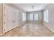 Formal dining room with tile floors, chandelier, and natural light from multiple windows at 2114 Twin Falls Dr, Henderson, NV 89044