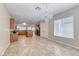 Open dining area adjacent to the kitchen, featuring chandelier and tile flooring at 2114 Twin Falls Dr, Henderson, NV 89044