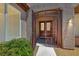View of the secure gated entry leading to the home's double front doors framed by desert landscaping at 2114 Twin Falls Dr, Henderson, NV 89044