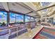 Bright hallway showcases sleek design, with expansive windows overlooking lush greenery and seating arrangements at 2114 Twin Falls Dr, Henderson, NV 89044