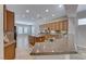 Well-lit kitchen showcases tile floors, granite counters, stainless appliances, and access to dining at 2114 Twin Falls Dr, Henderson, NV 89044