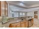Open-concept kitchen with breakfast bar overlooking the living room area and backyard at 2114 Twin Falls Dr, Henderson, NV 89044