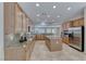 Spacious kitchen featuring granite countertops, island, tile floors, and stainless steel appliances at 2114 Twin Falls Dr, Henderson, NV 89044