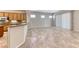 View of the living room with a breakfast bar that connects to a cozy kitchen and dining space at 2114 Twin Falls Dr, Henderson, NV 89044
